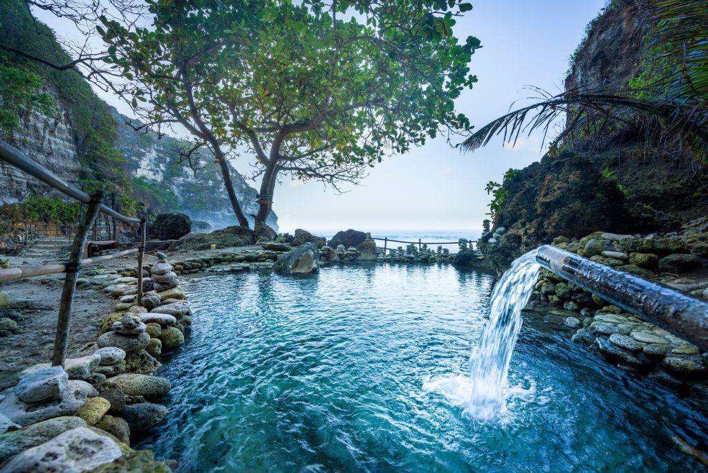 Nusa Penida boat tour cruising past hidden beaches and crystal-clear waters